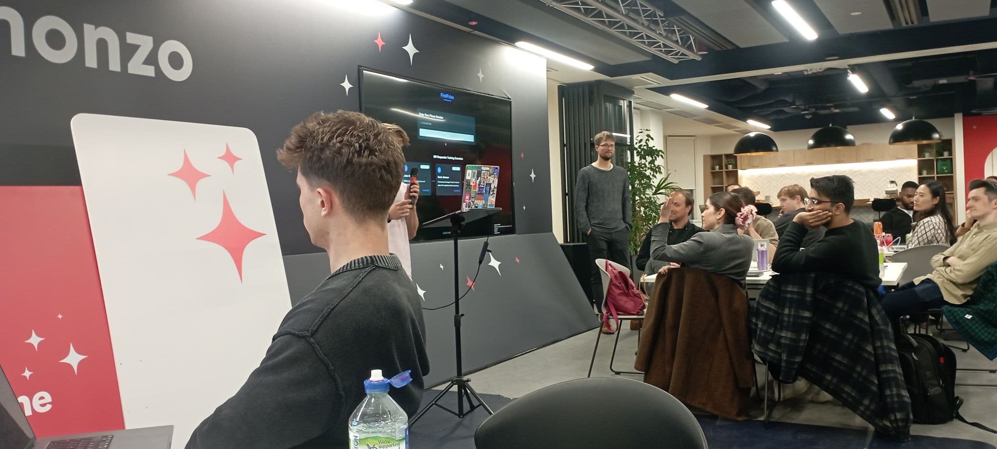 AI Tinkerers event room with speaker and audience